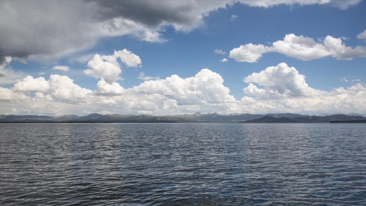 Yellowstone Lake under summer clouds, the Absaroka Mountains on the far shore