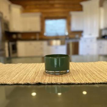 Imagine a cozy kitchen in a cabin, where the soft flicker of a candle adds a touch of warmth and intimacy to the rustic space.