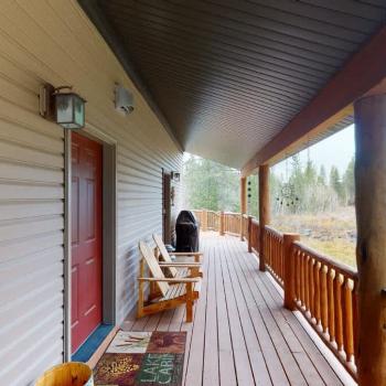 Beautiful open deck with a grill and seating.