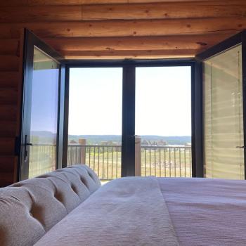 The master bedroom features log walls that create a calm and relaxing environment.
