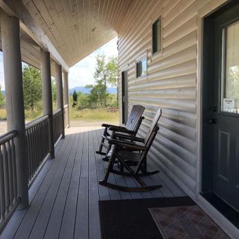 Patio with seating to enjoy the beautiful landscapes of the cabin.