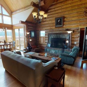 Living room with large open windows illuminating the room.