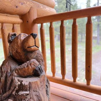 Carved bear on the balcony overlooking driveway