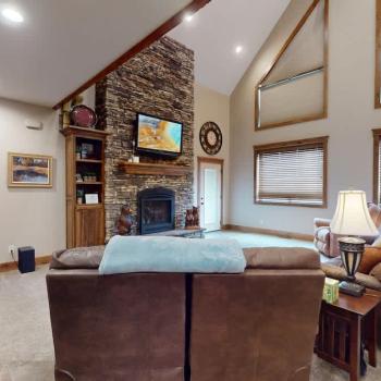 Open living room with fireplace and tv for entertainment.