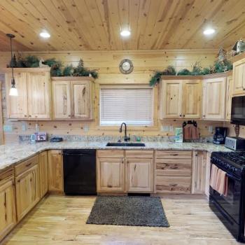 Full size kitchen equipped with appliances, pots and pans, dishes, utensils, and basic cooking essentials.