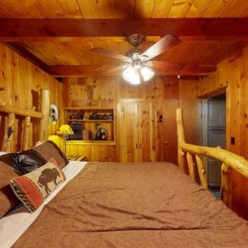 Beautiful bedroom with wood paneling.