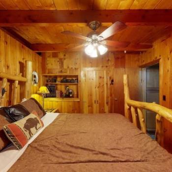 Beautiful bedroom with wood paneling.