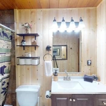 Full bathroom with a shower tub combo, sink vanity, and a toilet.