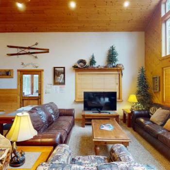 The living room is equipped with seating on the couches and a smart televisions for entertainment.