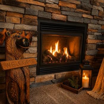 Cozy up next to the beautiful stone fireplace, complete with a charming carved wooden moose welcome statue and a warm, inviting hearth.