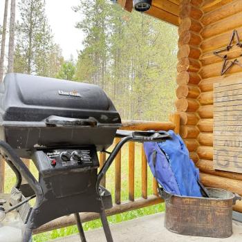 A propane grill on the front porch.
