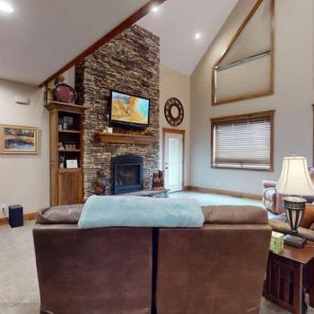 Open living room with fireplace and tv for entertainment.