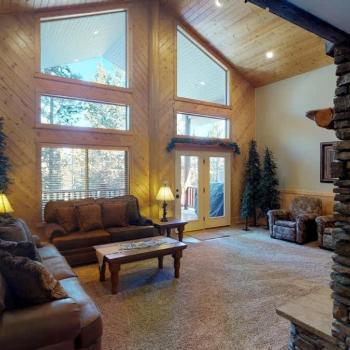Natural light pours in through large windows, tying it all together with a view of the forest just beyond.