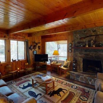 The living room offers a cozy space to unwind after a long day. A fireplace is included be sure to bring your own wood.