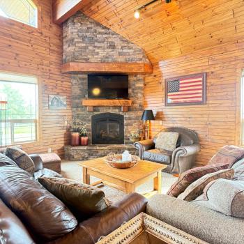 Experience cozy cabin luxury in this spacious living room featuring high
