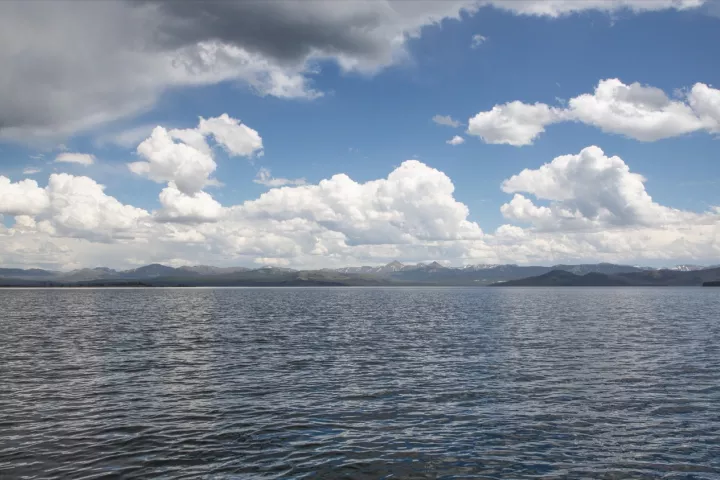 Yellowstone Lake under summer clouds, the Absaroka Mountains on the far shore