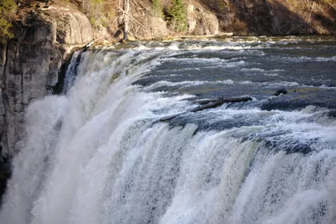 Upper Mesa Falls pouring over a wide basalt ledge