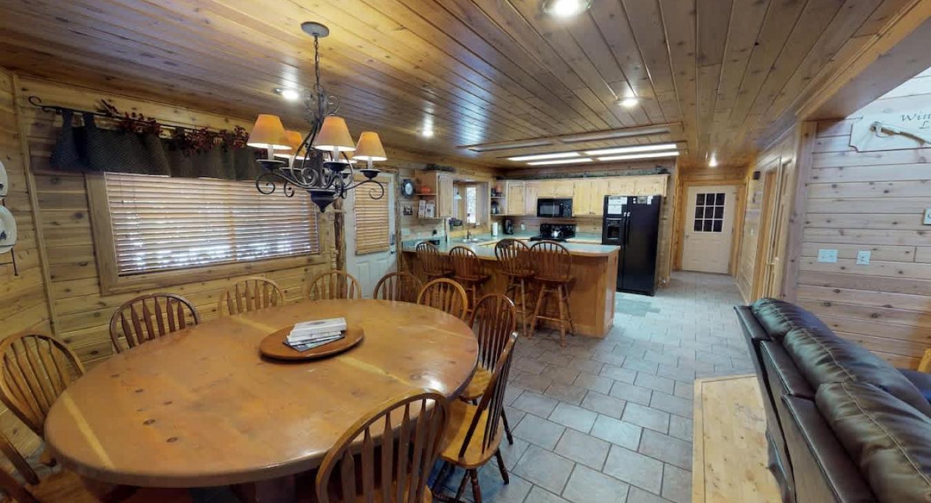 View the kitchen from the dining area with the open concept of the cabin.