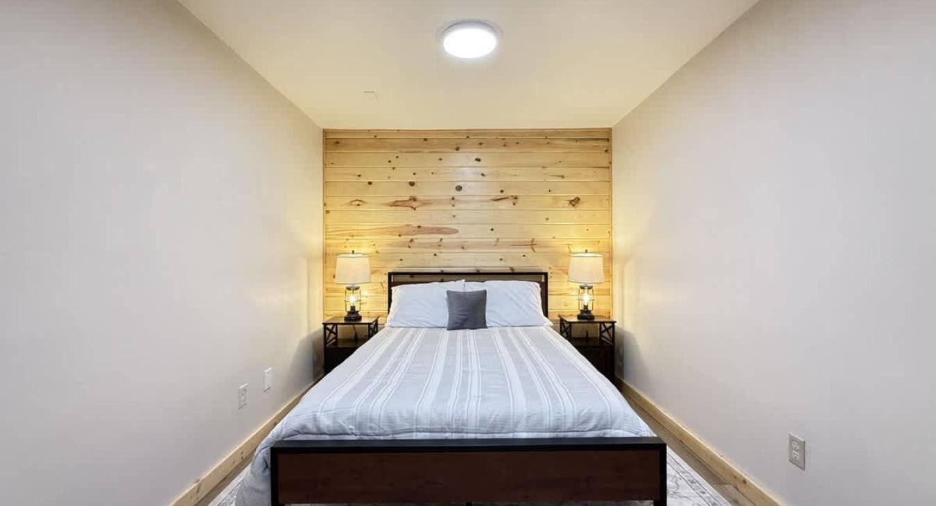 Basement bedroom #1 with a queen bed.