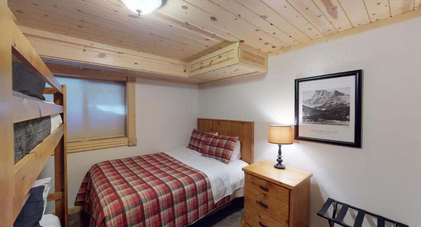 Bedroom #5 located downstairs with Queen bed and bunk bed,
