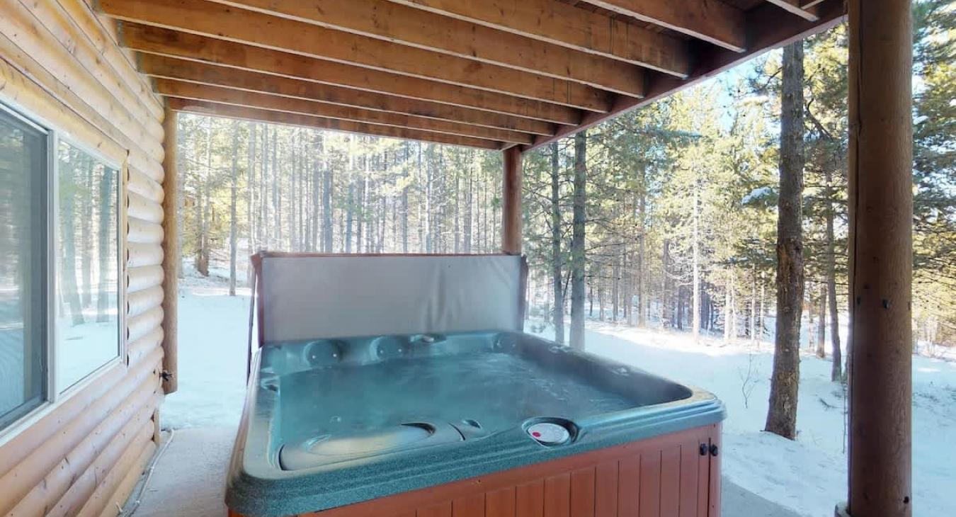 Hot tub located outside for everyone to relax during your stay.