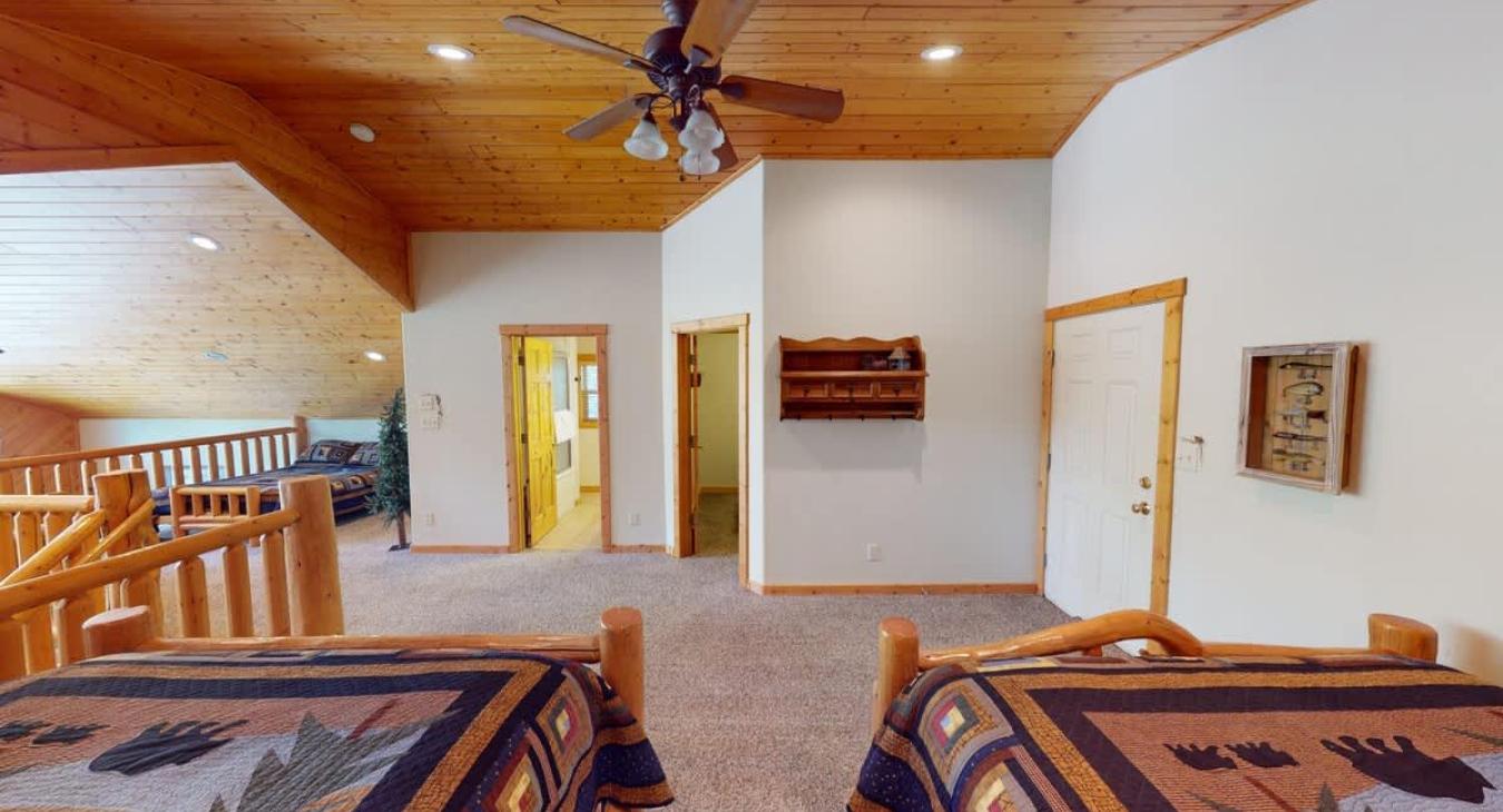 Across from the beds is the third bedroom and upstairs shared bathroom.