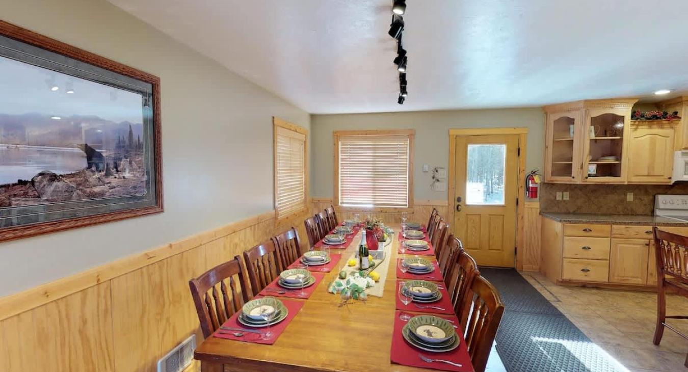 Dining room table perfect for up to 12 people with more seating available at the kitchen island.