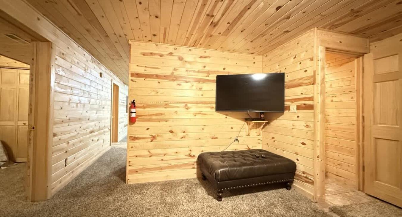 Basement level with smart tv an seating.