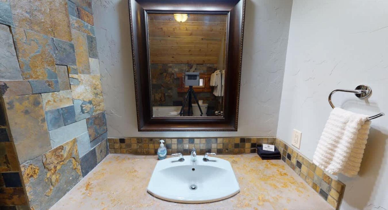 Ensuite bathroom with tub, standing shower, toilet, and sink.