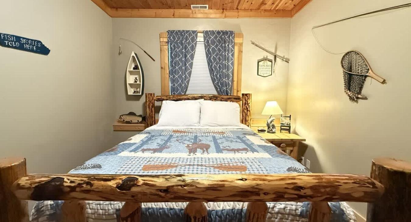 Bedroom #5 located in the basement with a Queen size bed.