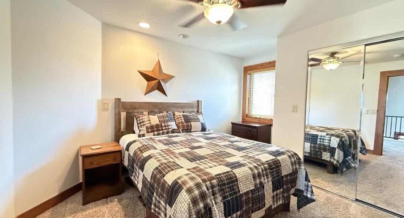 Bedroom #2 located upstairs with a Queen size bed.