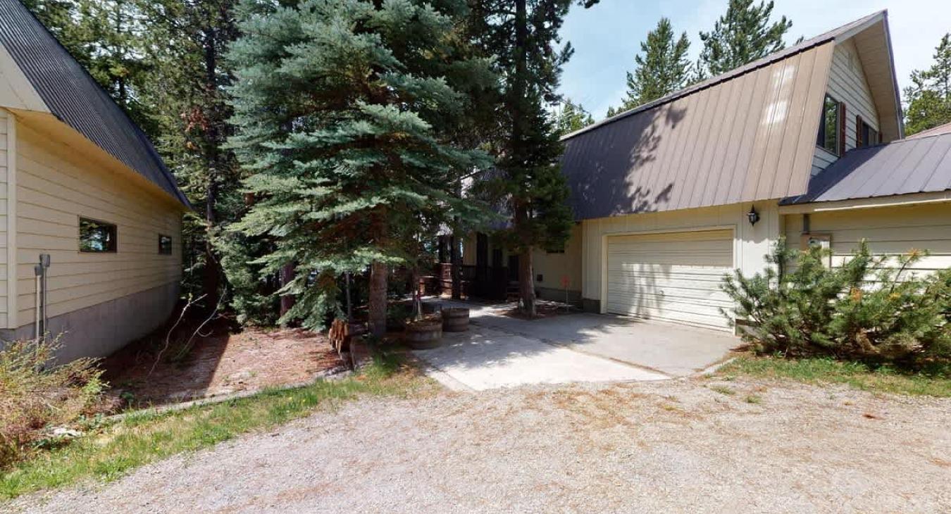 This cabin is nestled in the towering pine trees.