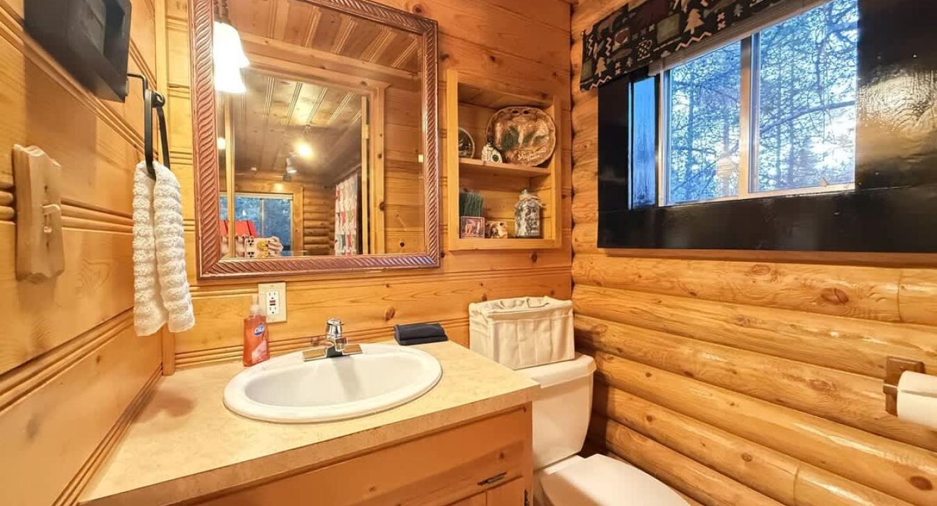 Upstairs half bathroom with sink and toilet.