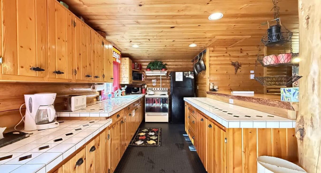 Full kitchen with counter space, appliances, and basic spices.