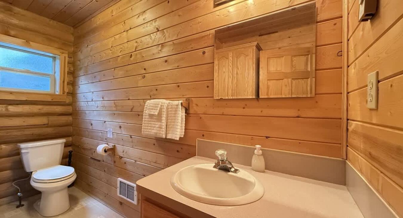 Upstairs bathroom with shower/tub, toilet, and sink.