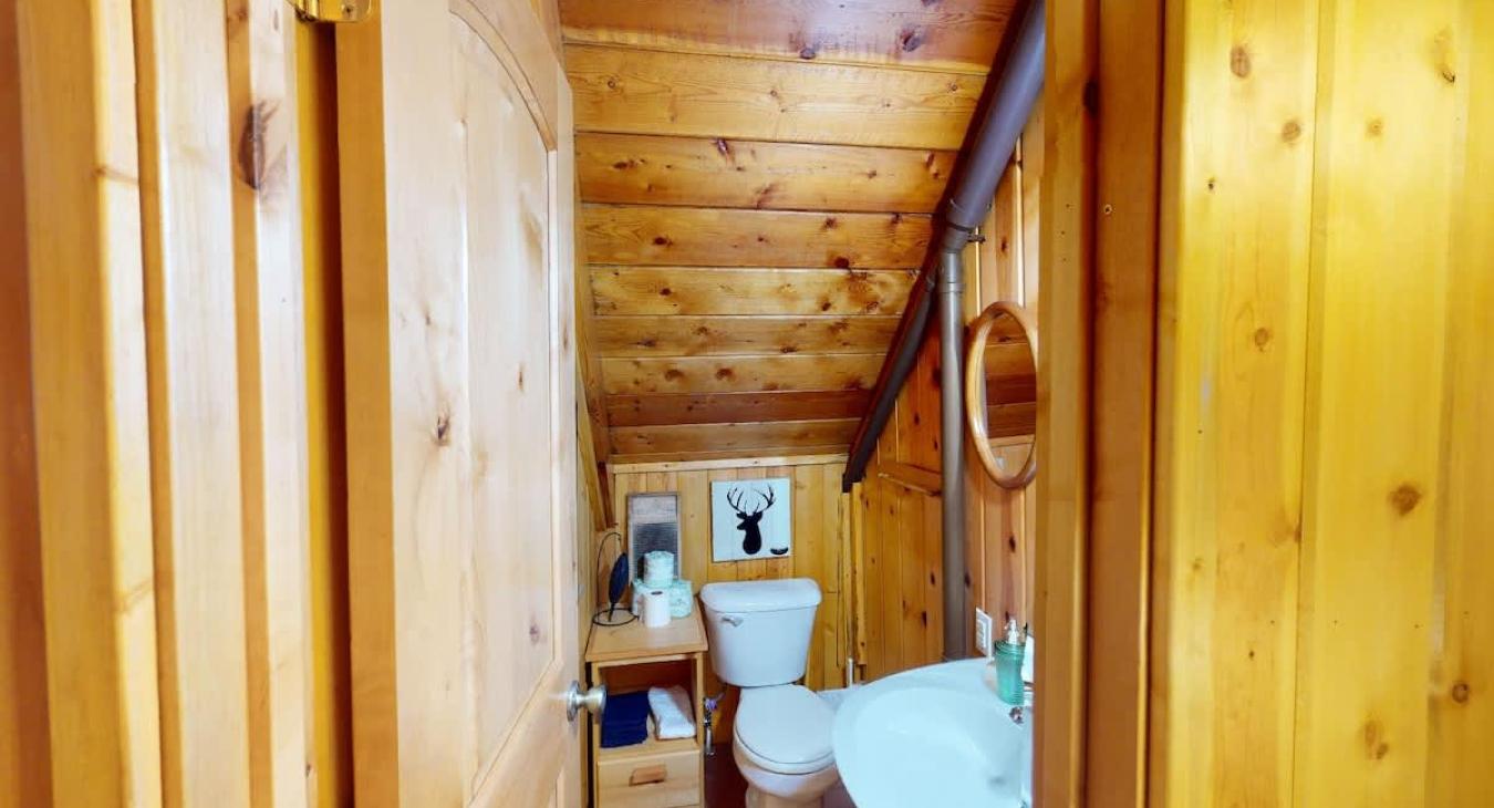 Small bathroom upstairs with toilet and sink.