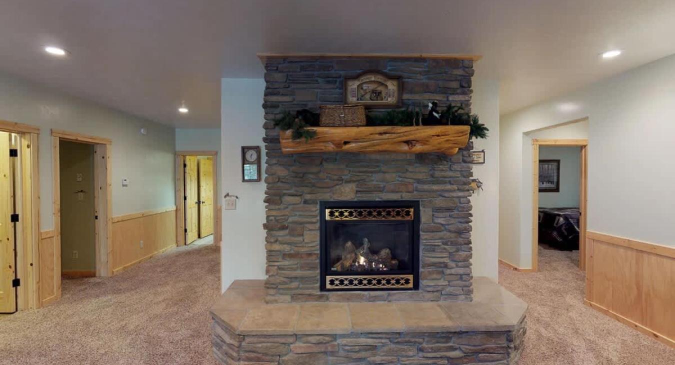 Fireplace in the basement living room to relax after a long day outdoors.