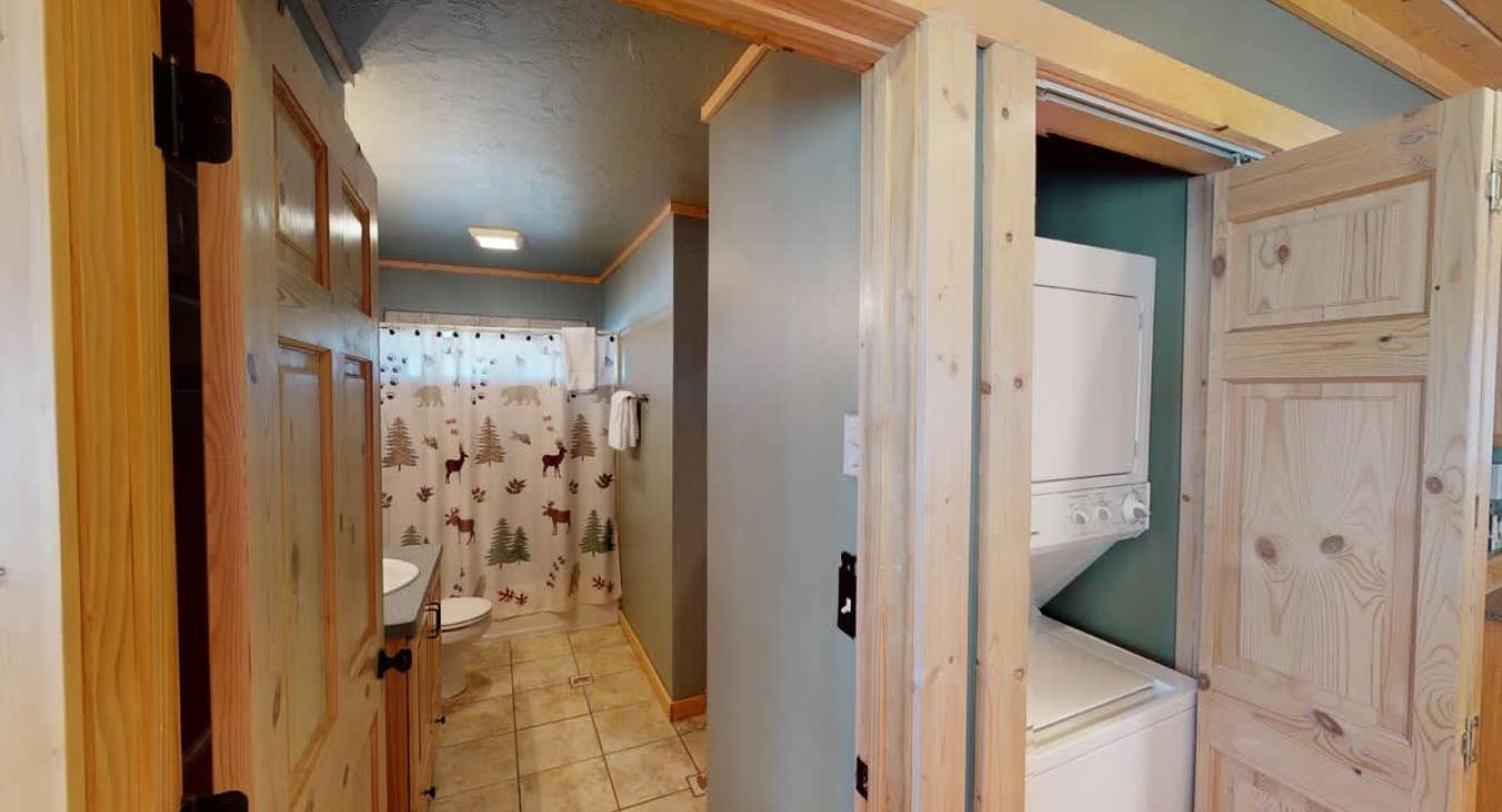 Downstairs bathroom with a laundry closet adjacent. Full size washer and dryer with laundry soap provided.