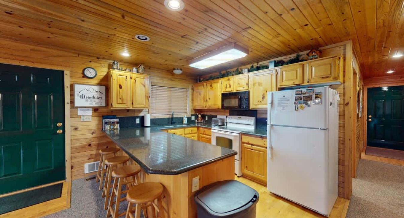 Fully equipped kitchen with appliances, pots and pans, dishes, utensils, and basic cooking essentials.