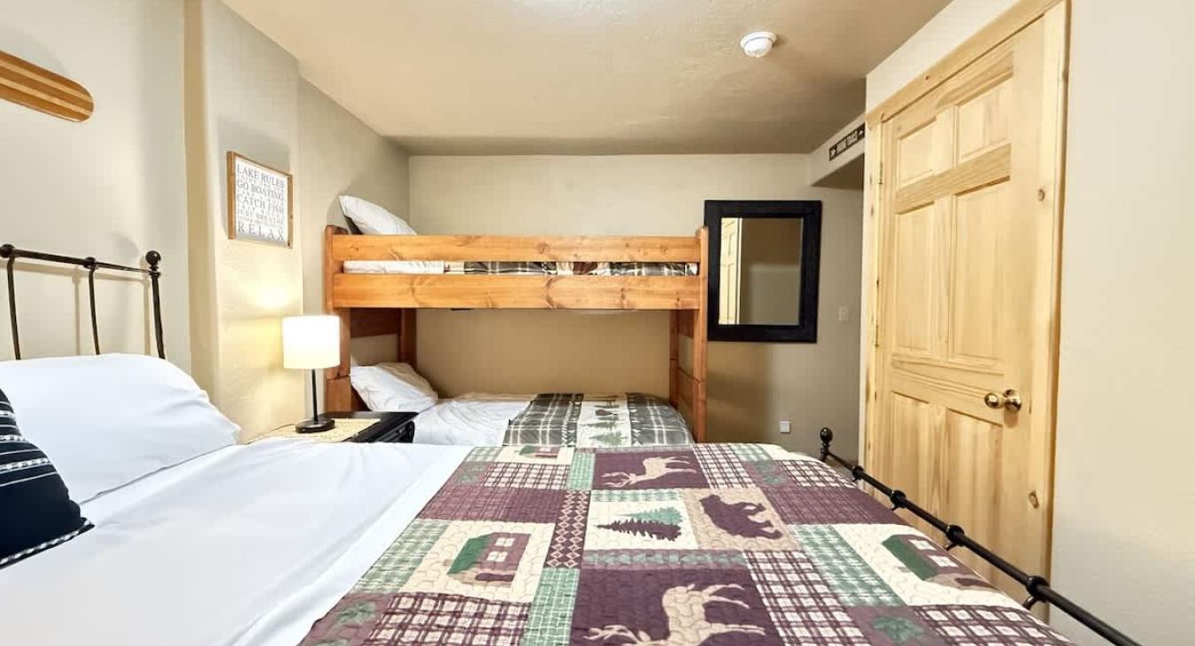 This room features a queen bed and a bunk bed with 2 twin beds.