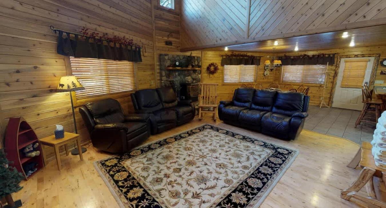 Living room has tall ceilings that really make the cabin feel cozy.