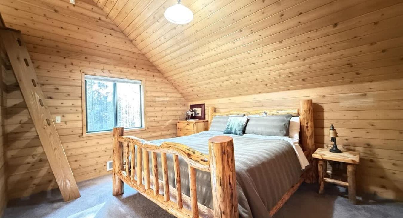Bedroom located upstairs with a king size bed. Ladder loft with twin size bunk beds.