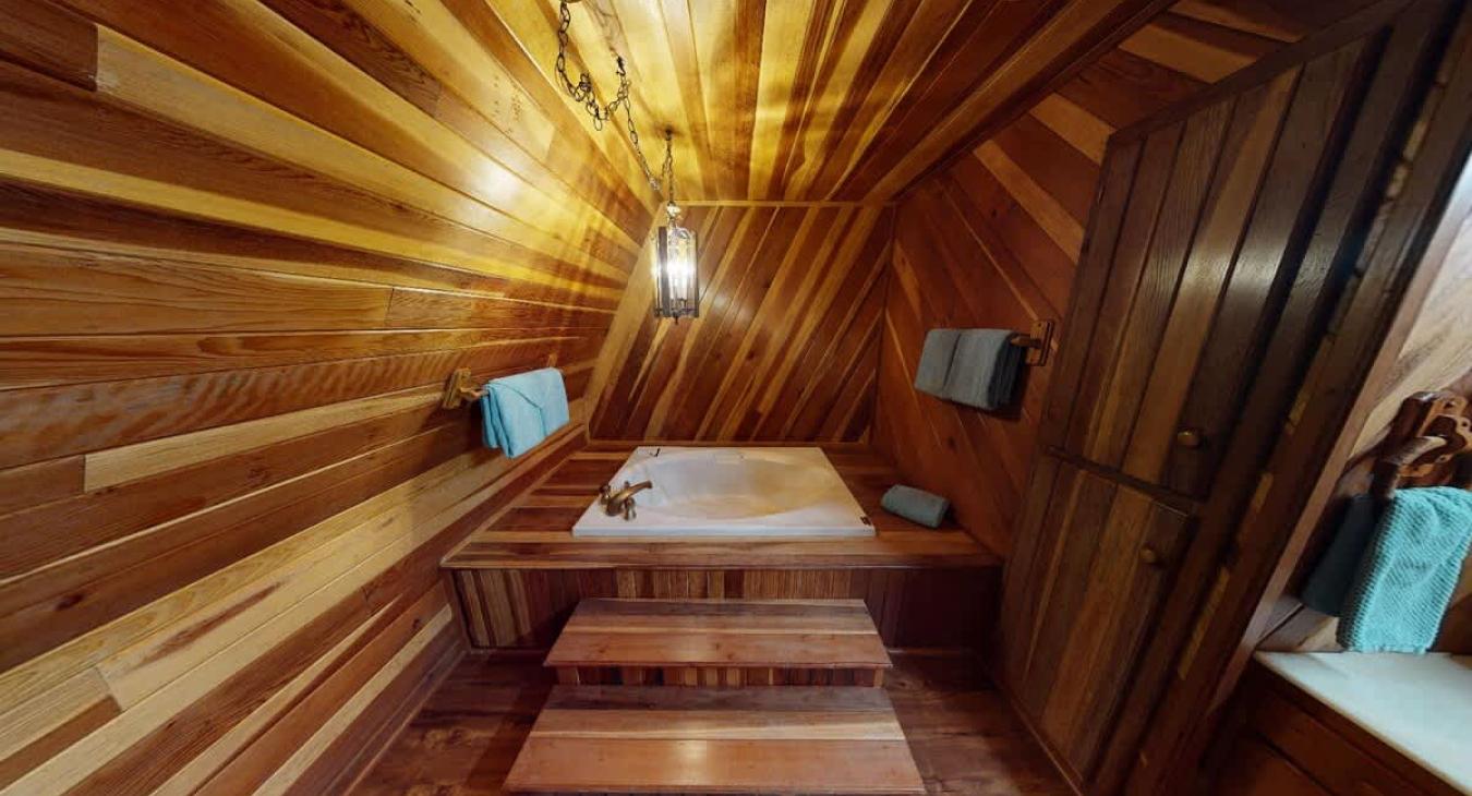 Upstairs shared bathroom with tub, toilet, and sink vanity.
