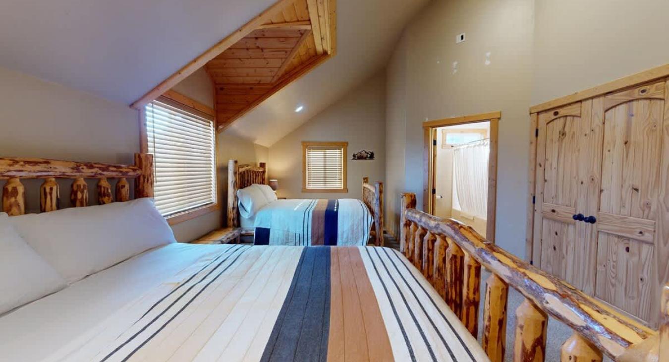 Tucked discreetly into one corner is the ensuite bathroom, accessible through a wooden frame door.