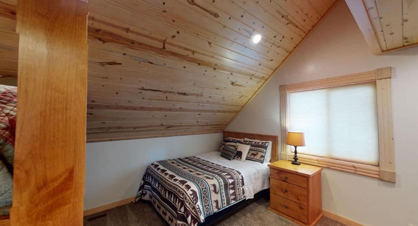 Bedroom #2 located upstairs with a Queen and a bunk bed.