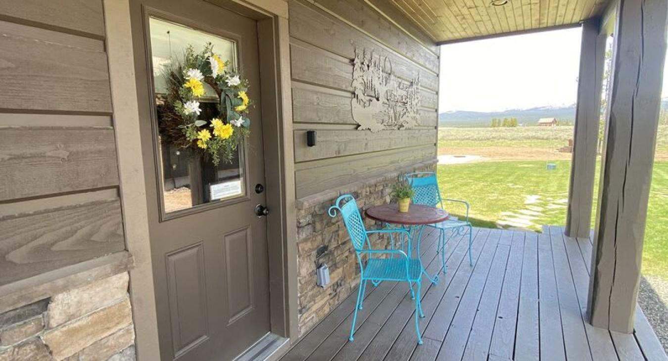 On the porch there is seating to enjoy the beautiful mornings at this cabin.