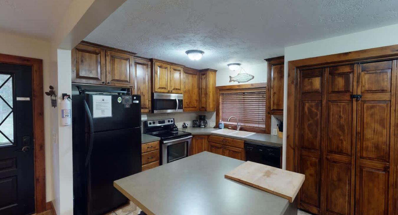This kitchen is equipped with basic appliances, dishes, and cookware you might need,