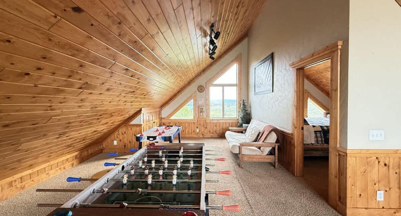 Large loft space with lots of natural light during the day from the windows.