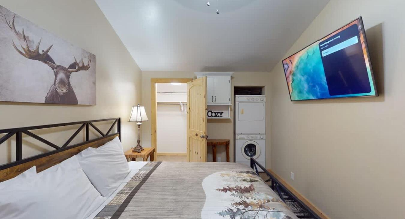 Relax after a long day in this bedroom that brings a mix of modern amenities with a rustic feel.