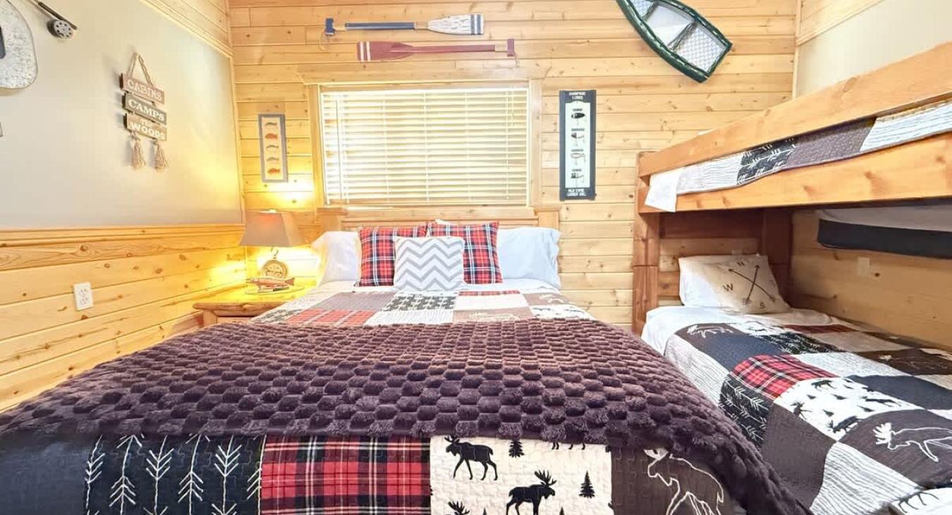 Welcome to the third bedroom with a queen bed and 2 twin beds on a bunk bed.